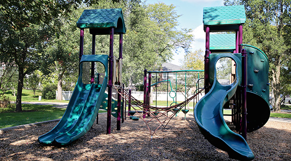 A play structure at Mallard park in the shade of trees